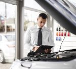 car-dealer-signing-papers
